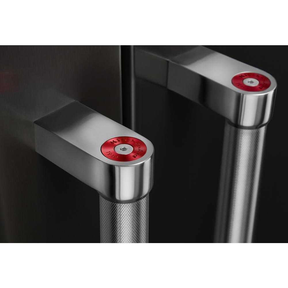 Close-up of stainless steel refrigerator door handles with textured grip and red circular accents on top from KitchenAid appliance collection