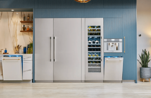 Modern kitchen featuring panel-ready built-in refrigerator column and integrated wine cooler with stainless steel accents