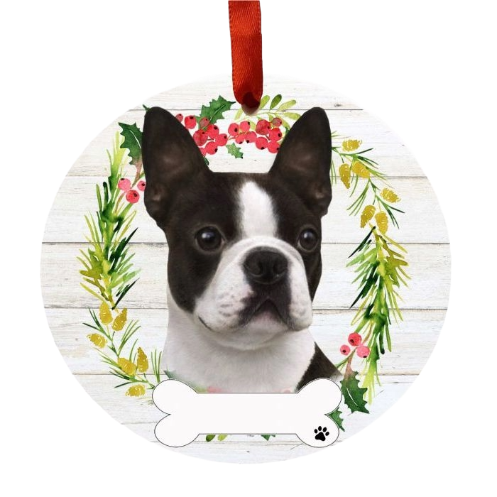Round Christmas ornament featuring a Boston Terrier face with a festive wreath and red hanging ribbon