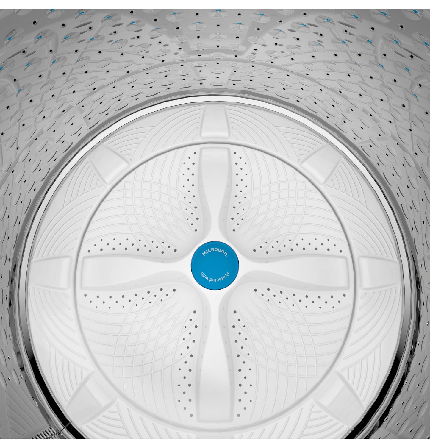 Top view inside washer drum showing textured wash plate design with Microban antimicrobial feature in top load washer drum