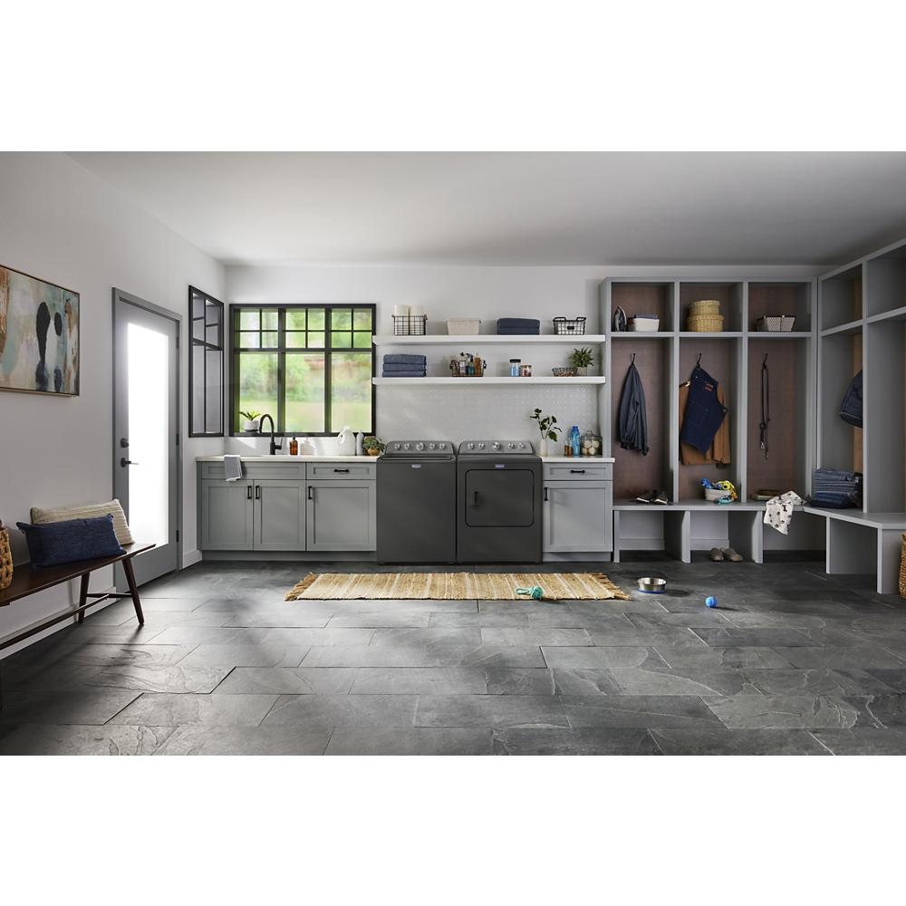 Laundry room featuring matte black top load washer and dryer with gray cabinetry, built-in storage, and pet accessories nearby.