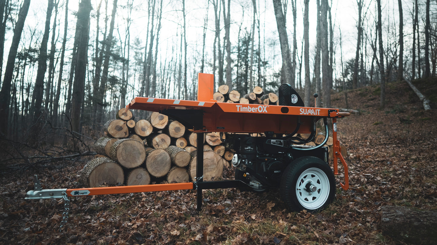 Orange TimberOX Summit 30-ton log splitter with black engine and white wheel near stacked logs in wooded area for home use
