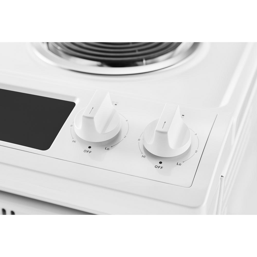 Close-up of white electric range knobs with adjustable heat settings from kitchen and appliances collections