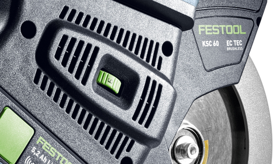 Close-up of Festool cordless compound miter saw motor housing and blade guard, featuring power switch and branding.