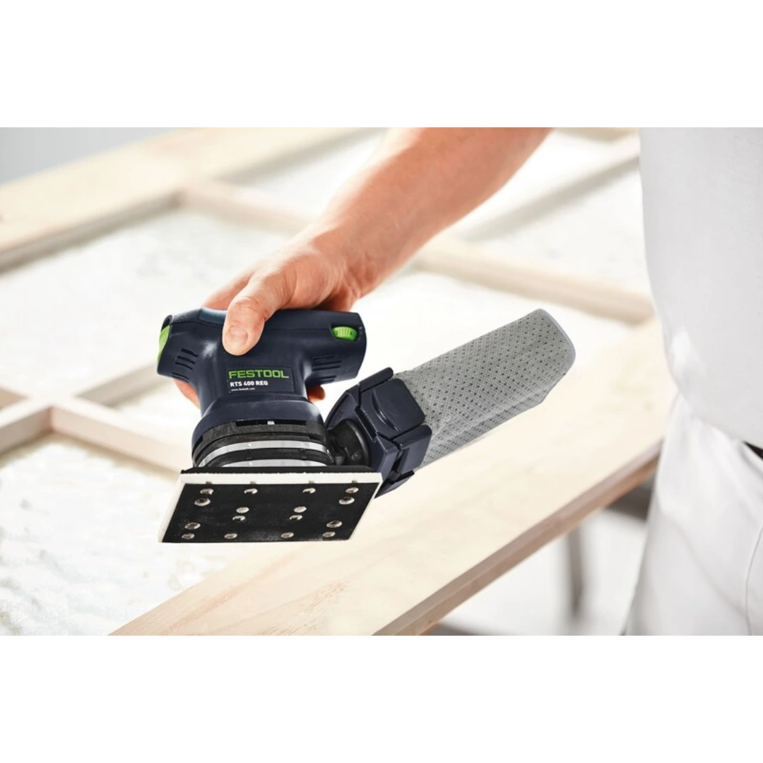 Person holding Festool RTS 400 sanding tool with Stickfix pad on wooden frame in woodworking tool accessories collection