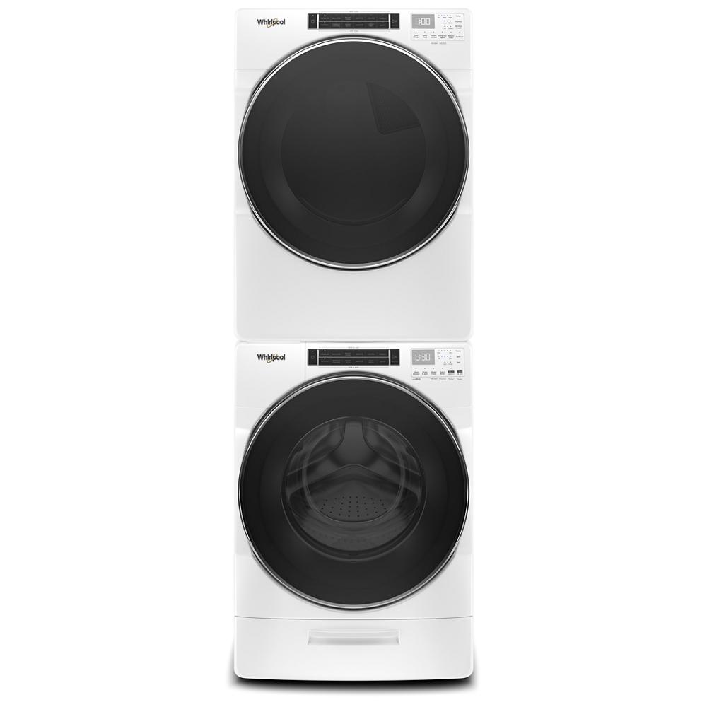 Stacked white front load washer and dryer with digital controls in a modern laundry appliances setting
