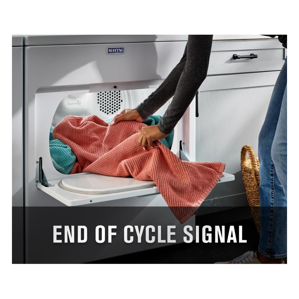 Person removing coral and teal textured blankets from a white top load electric dryer in the dryers collection