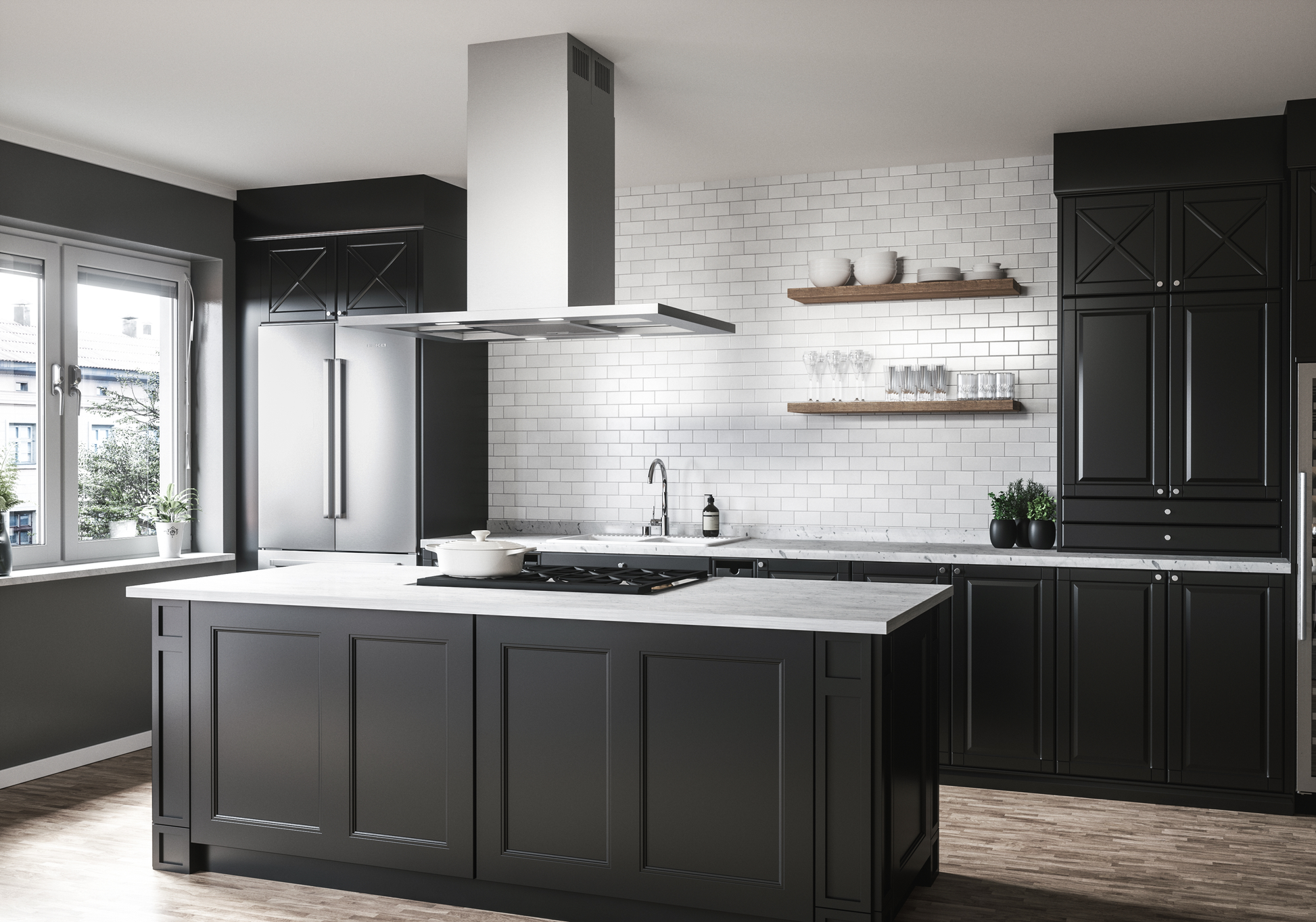 Low-profile stainless steel island range hood with glass canopy above black kitchen island in modern kitchen setting