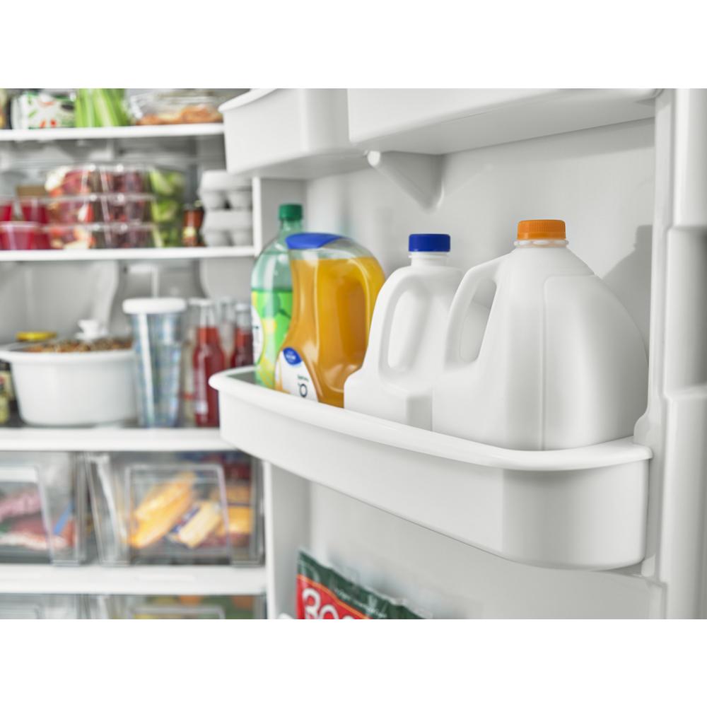Open refrigerator door showing gallon jugs, juice, soda, and fresh food with LED lighting in kitchen appliances collections