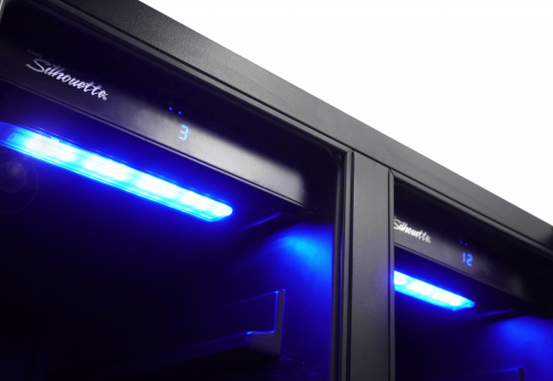 Close-up of dual temperature zone beverage center with blue LED lighting in kitchen appliances and beverage centers collection