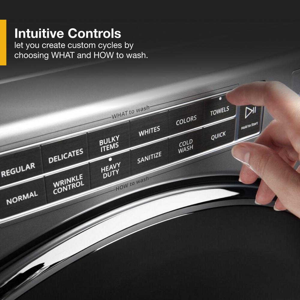 Hand selecting cycle options on control panel of front load washer in washers and appliances collection