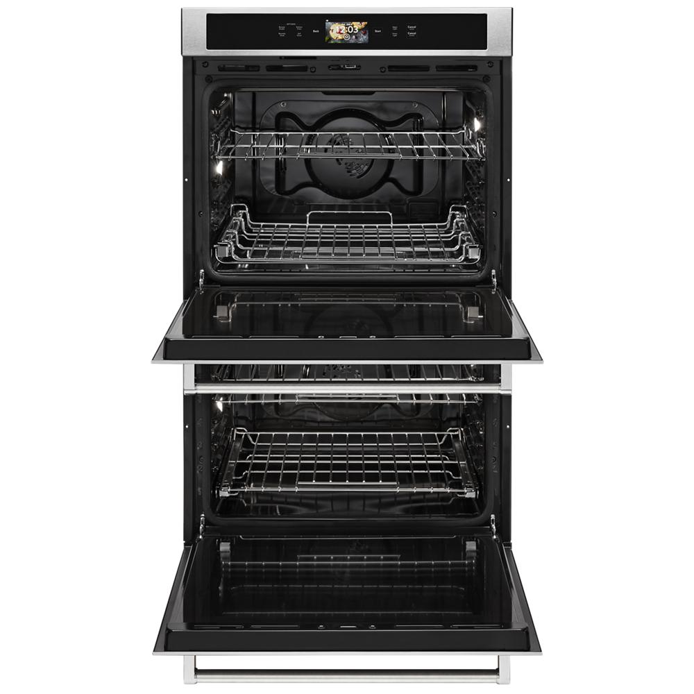 Open stainless steel double wall oven with multiple racks and digital control panel from KitchenAid appliances collection