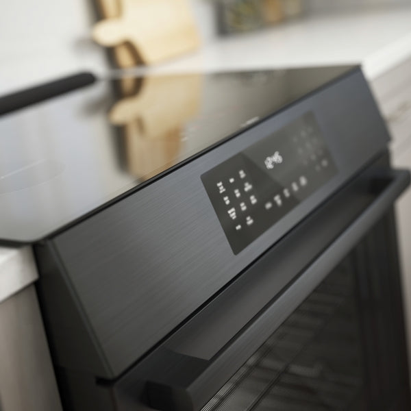 Black stainless steel 30-inch induction slide-in range with touch control panel in modern kitchen setting