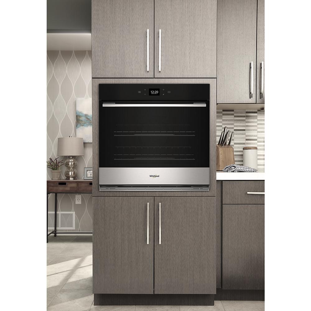 Built-in single wall oven with stainless steel trim, digital display, and modern kitchen cabinetry in Appliances collection