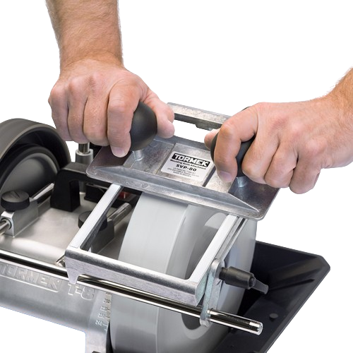 Hands using a sharpening jig on a grinding wheel for precise blade edge honing in tools and home improvement tasks