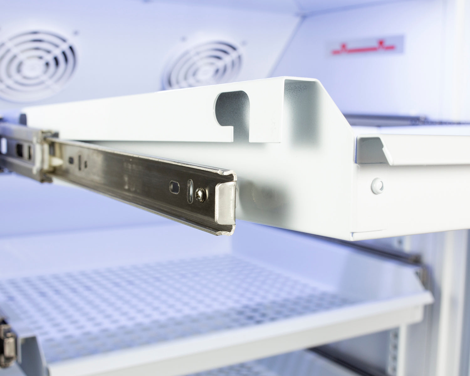 Close-up of removable metal drawer slide mechanism inside upright refrigerator from Refrigerators and Kitchenware collections