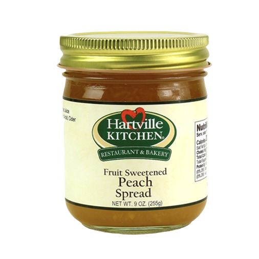 Glass jar of Hartville Kitchen peach spread sweetened with fruit juice, part of jams and jellies collection under $25