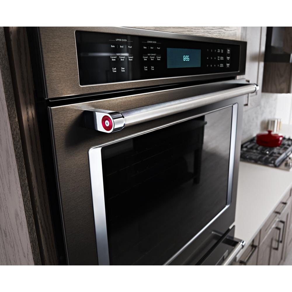 Close-up of stainless steel built-in oven with digital control panel in modern kitchen setting for KitchenAid collection