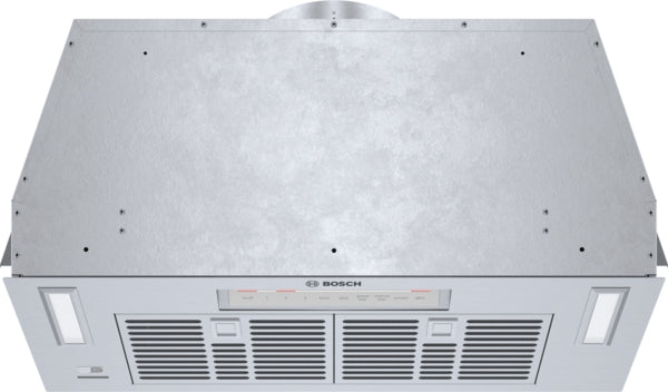 Stainless steel custom cabinet depth insert for range hood with ventilation grills and control panel from Bosch Appliances collection