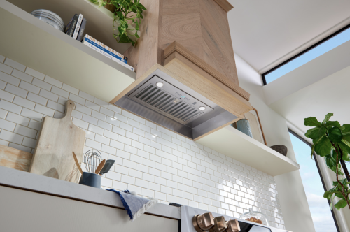 Stainless steel vent hood insert with SmartSense infrared sensor in modern kitchen from Over the Range Hoods collection