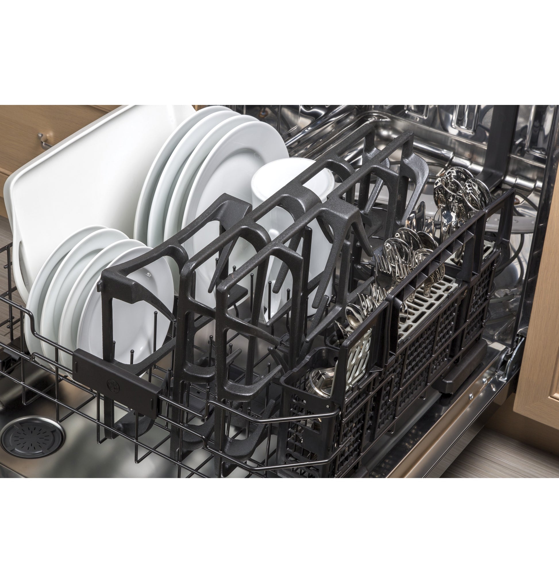 Open dishwasher loaded with clean white plates, cups, and silverware in kitchen and home improvement setting
