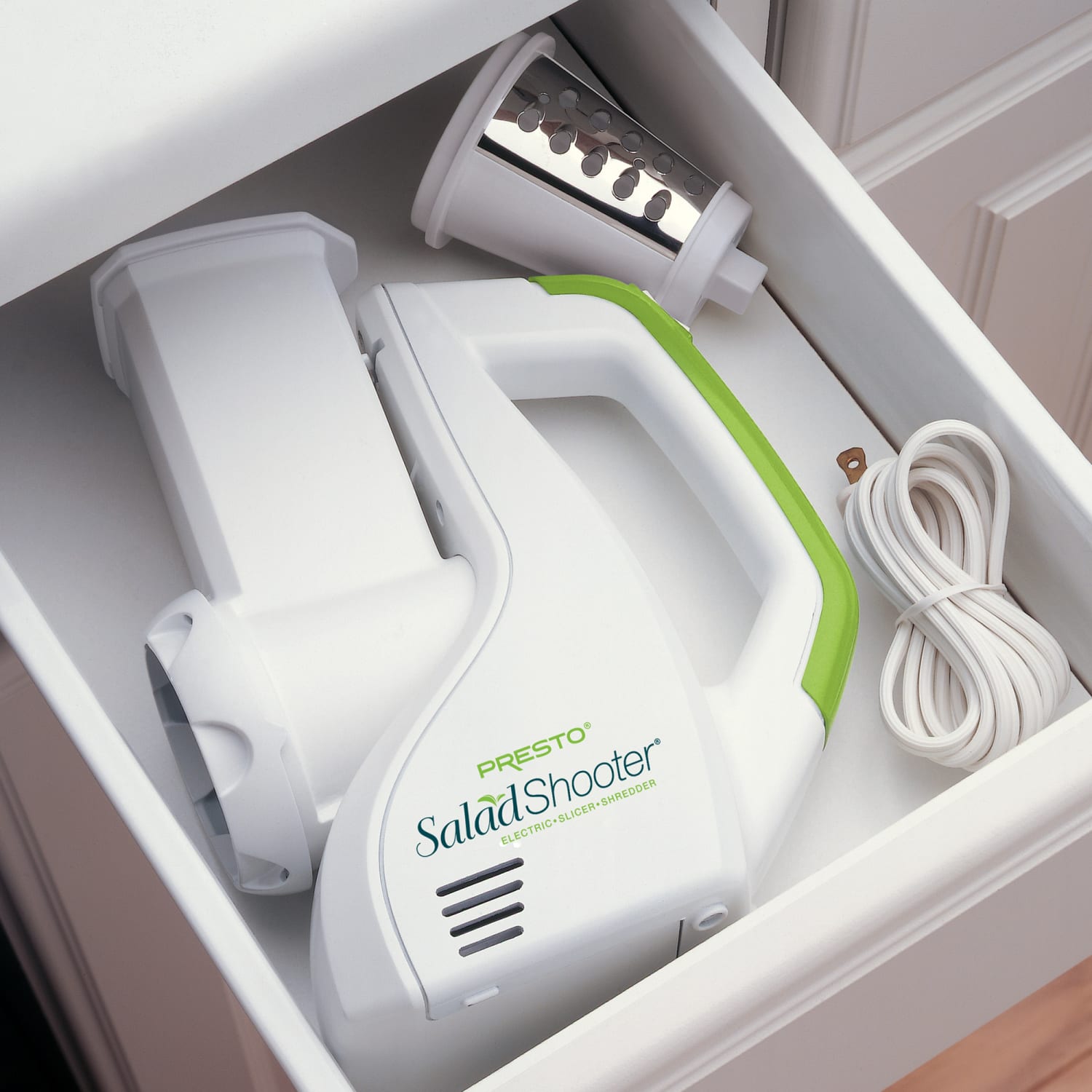 White and green compact electric slicer with interchangeable cones stored neatly in kitchen drawer under $100 small appliances collection