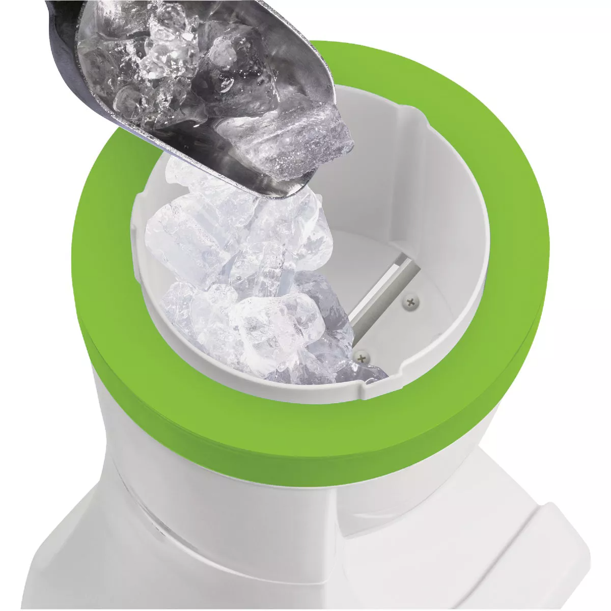 Scoop pouring ice cubes into a white and green electric shave ice and snow cone maker for dessert preparation
