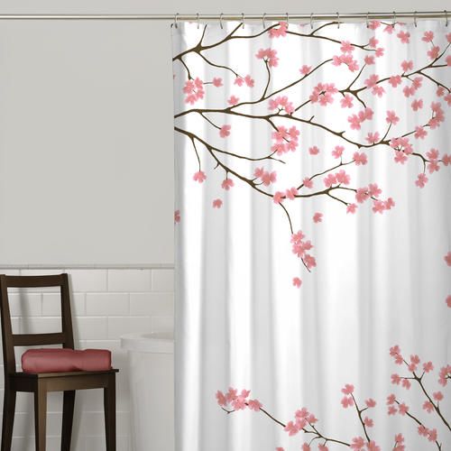 White polyester shower curtain decorated with delicate pink cherry blossoms and brown branches in bathroom setting
