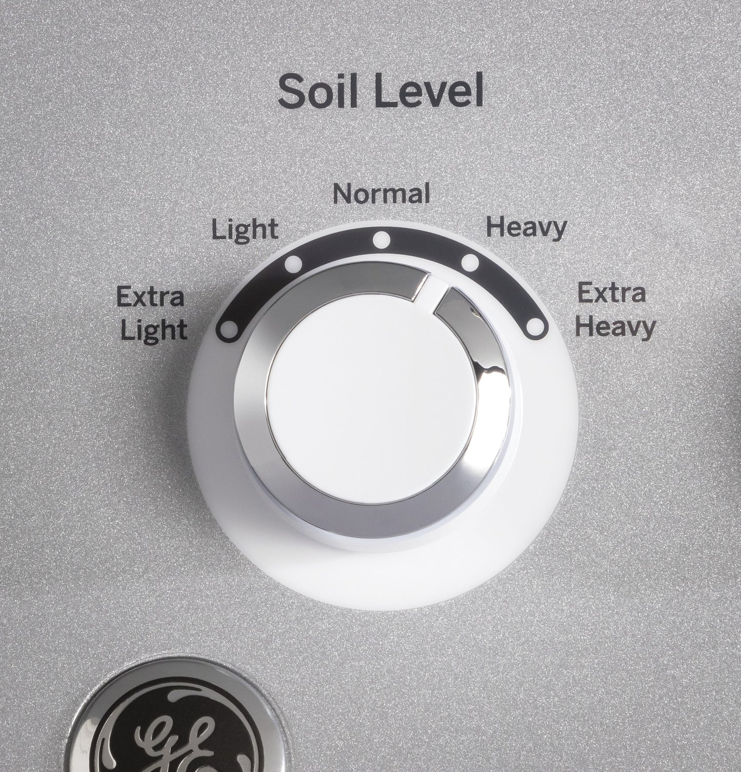 Close-up of soil level control knob on washer with settings ranging from extra light to extra heavy soil level