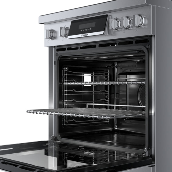 Open stainless steel induction freestanding range with ergonomic tilted control panel and heavy-duty metal knobs