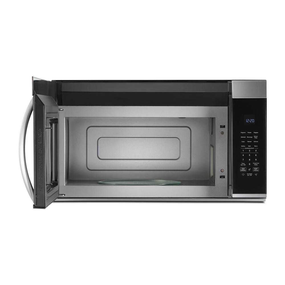 Open stainless steel over the range microwave with digital control panel and glass turntable inside in kitchen appliances collection