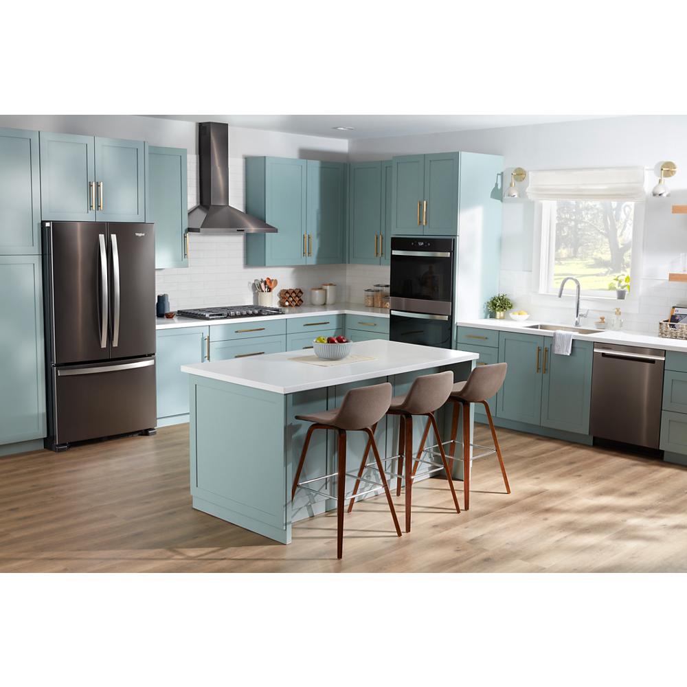 Bright kitchen with blue cabinetry, stainless steel appliances including built-in double wall oven and dishwasher, hardwood floor flooring