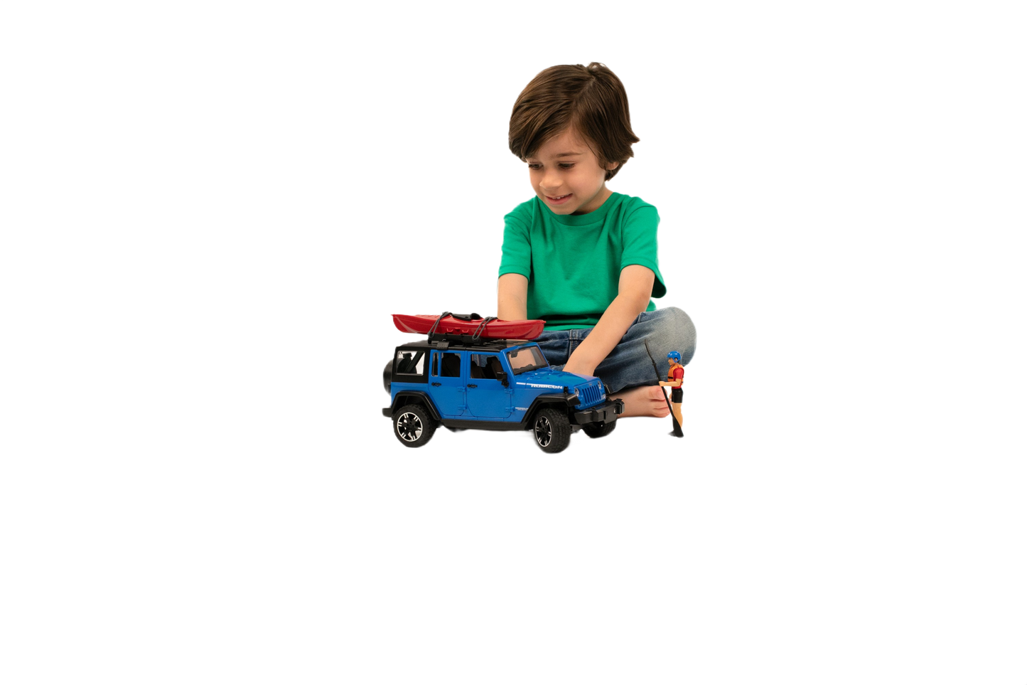 Young child playing with blue Bruder Jeep Wrangler Rubicon toy featuring red kayak on roof outdoors