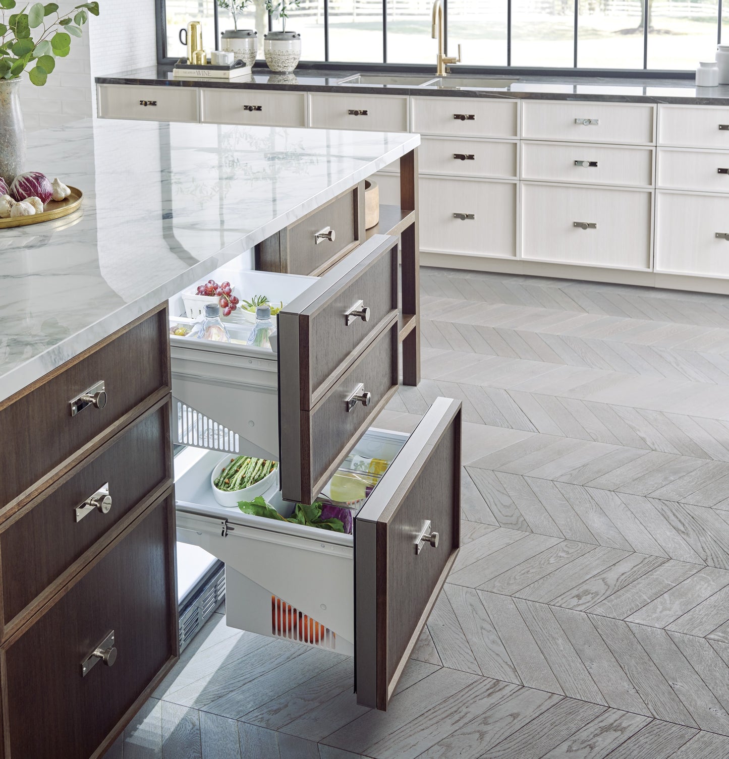 Open view of panel-ready double-drawer refrigerator integrated into dark wood cabinetry in kitchen and appliances collections