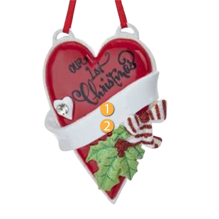 Red heart-shaped Christmas ornament with white ribbon, holly leaves, and "Our 1st Christmas" lettering under $50 decor
