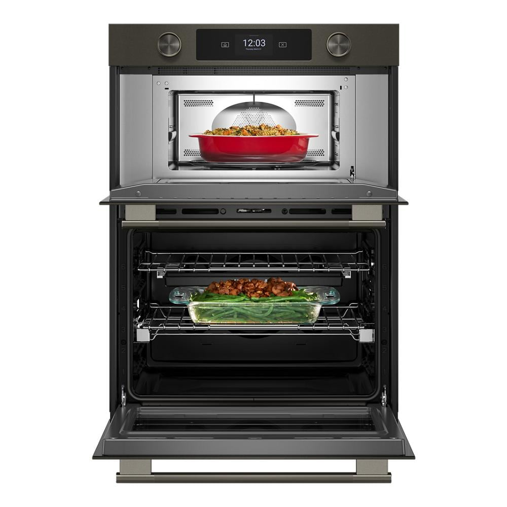 Open dual electric wall oven in black ore finish with digital display, upper microwave combo, and food inside from KitchenAid Appliances.