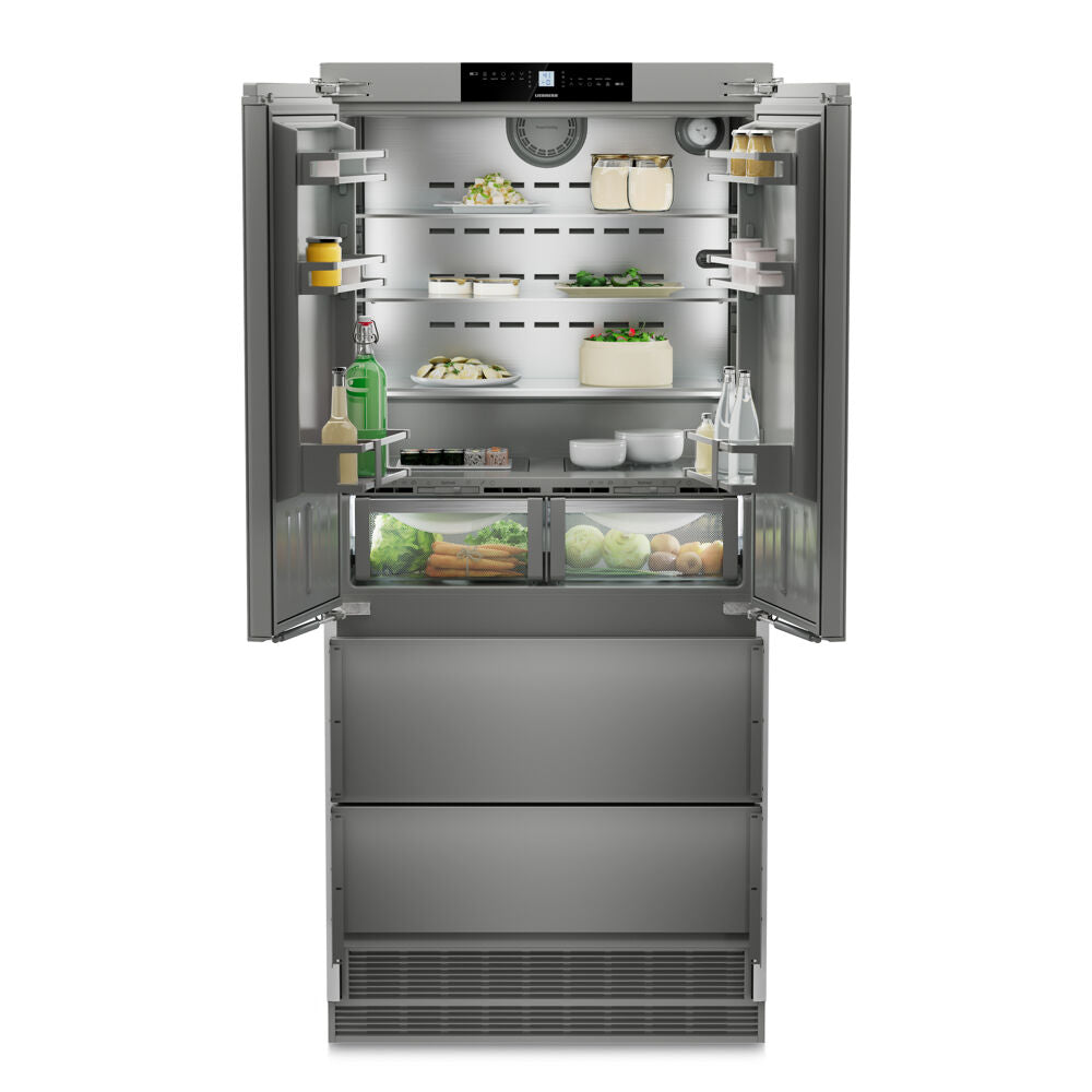 Built-in stainless steel French door refrigerator with open doors showing organized shelves and fresh produce drawers