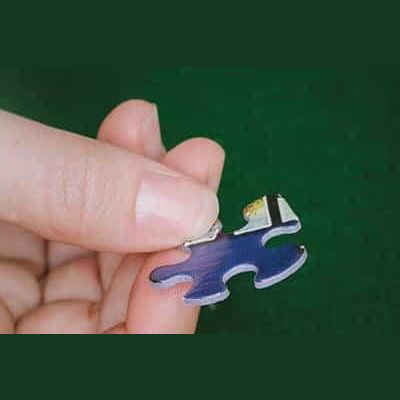 Hand holding a single blue puzzle piece for Toys & Games and Puzzles collections under $50.