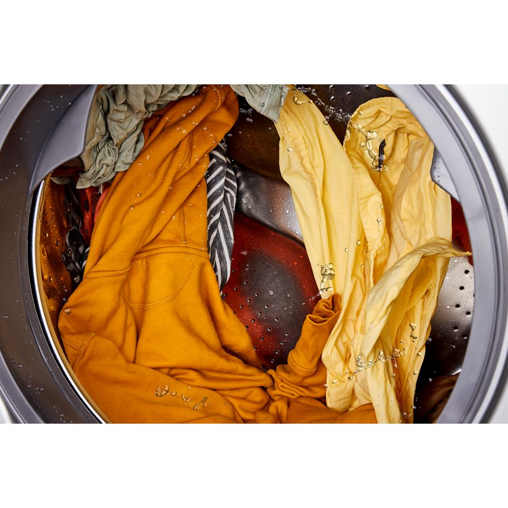 Front load washer drum filled with colorful clothes soaking in water in Washers & Dryers collection