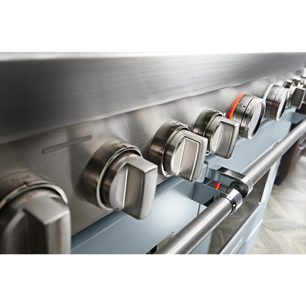 Close-up of stainless steel control knobs and oven handle on commercial-style dual fuel range in kitchenware collection