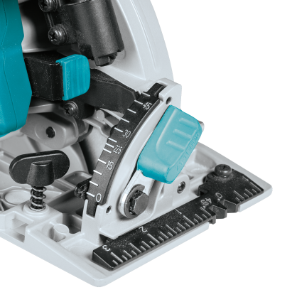 Close-up of angle adjustment and depth gauge on teal and black cordless circular saw for woodworking tasks