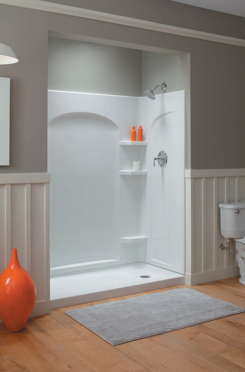 White curved end shower wall set with built-in shelves in bathroom featuring wood flooring and neutral-colored walls