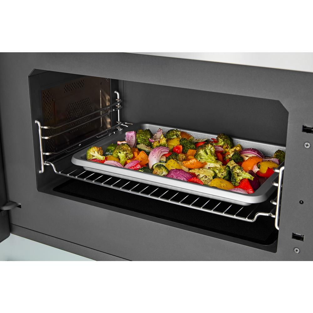 Tray of seasoned mixed vegetables roasting inside a built-in microwave oven from the Wall Oven and Microwave Combos collection