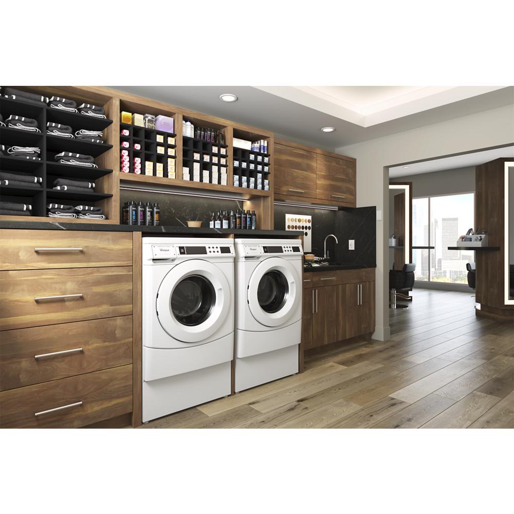 Modern laundry room with white front-load washers integrated into wood cabinetry and organized storage shelves above