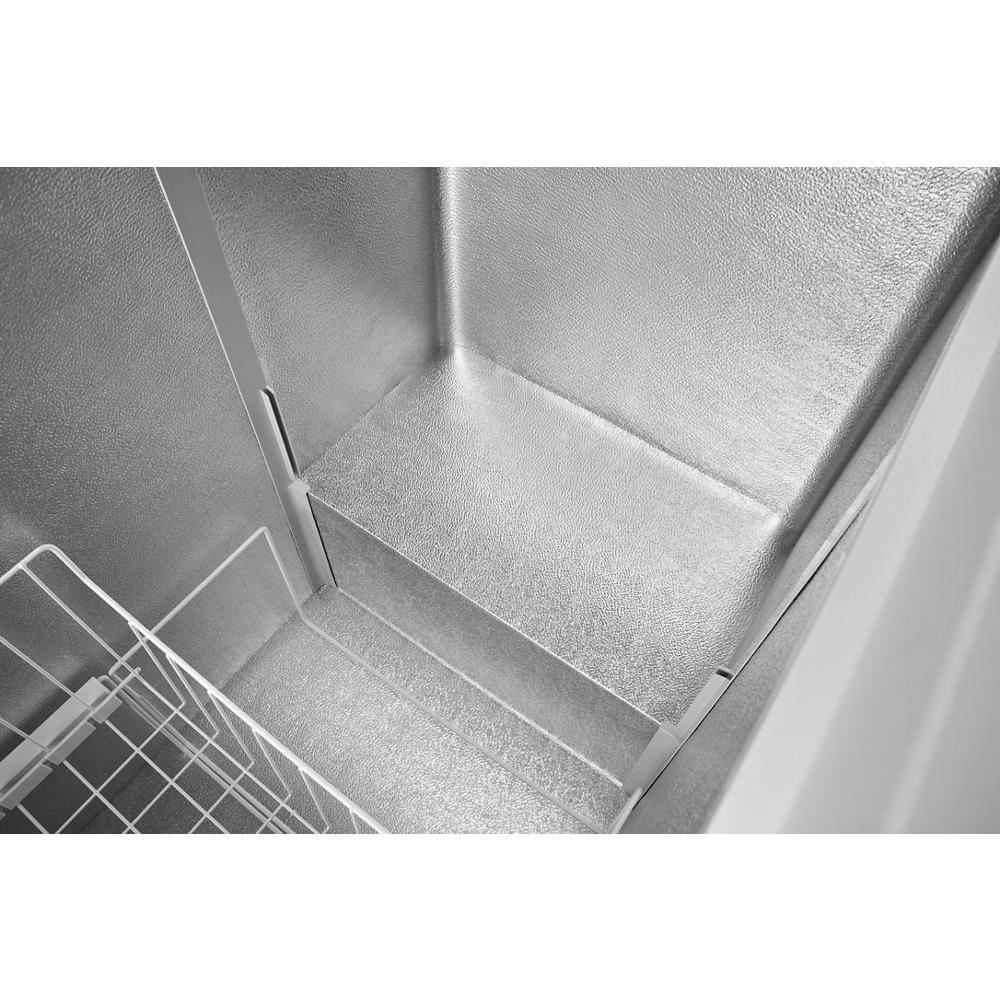 Interior view of a silver textured chest freezer compartment with metal storage basket from Freezers collection at Hartville Hardware
