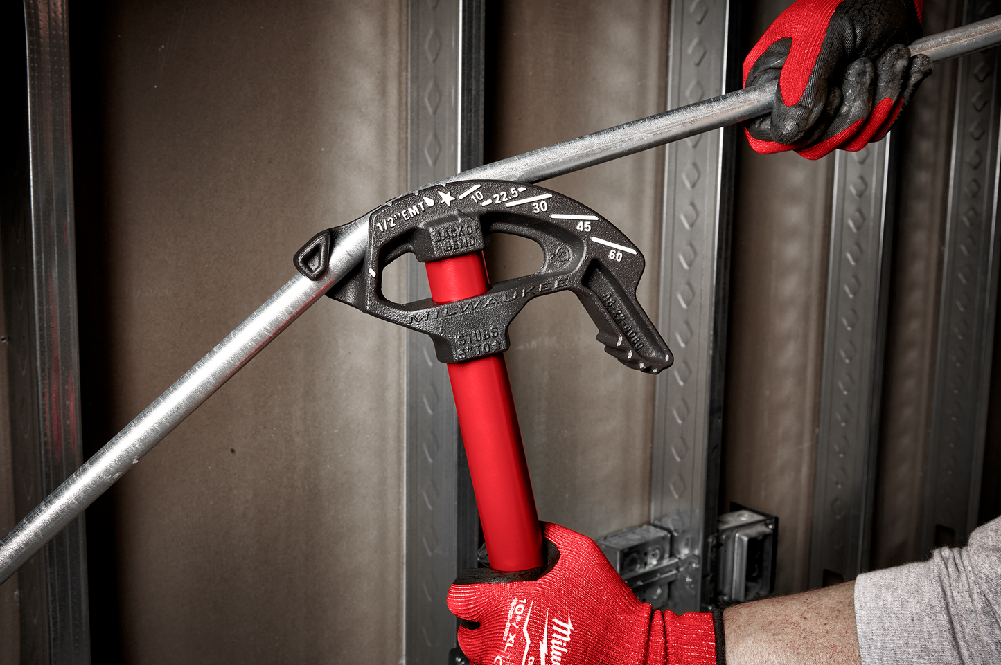 Milwaukee 1/2" EMT conduit bender with red handle and high visibility markings in use for electrical hand tools collection