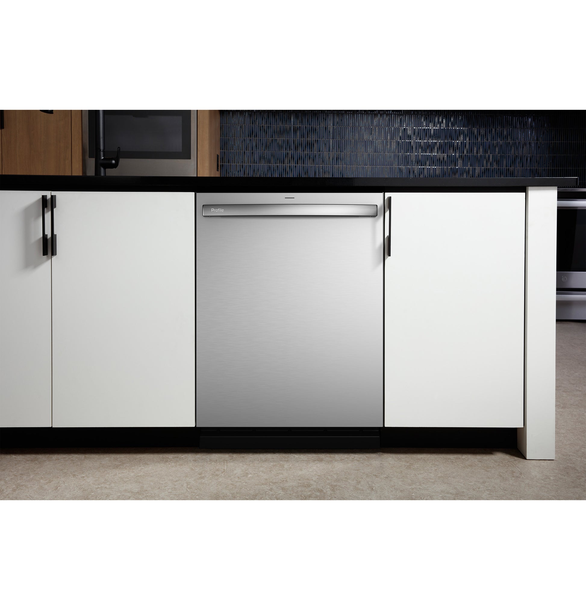 Built-in stainless steel dishwasher installed under black countertop between white cabinetry in modern kitchen setting from Dishwashers collection