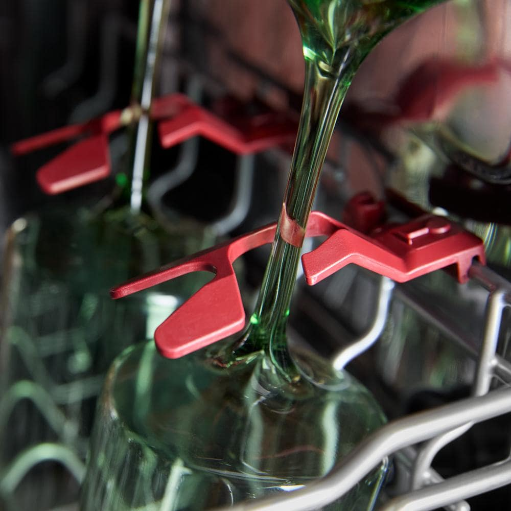 Close-up of red stemware holders securing wine glasses in third rack of KitchenAid dishwasher from appliances collection