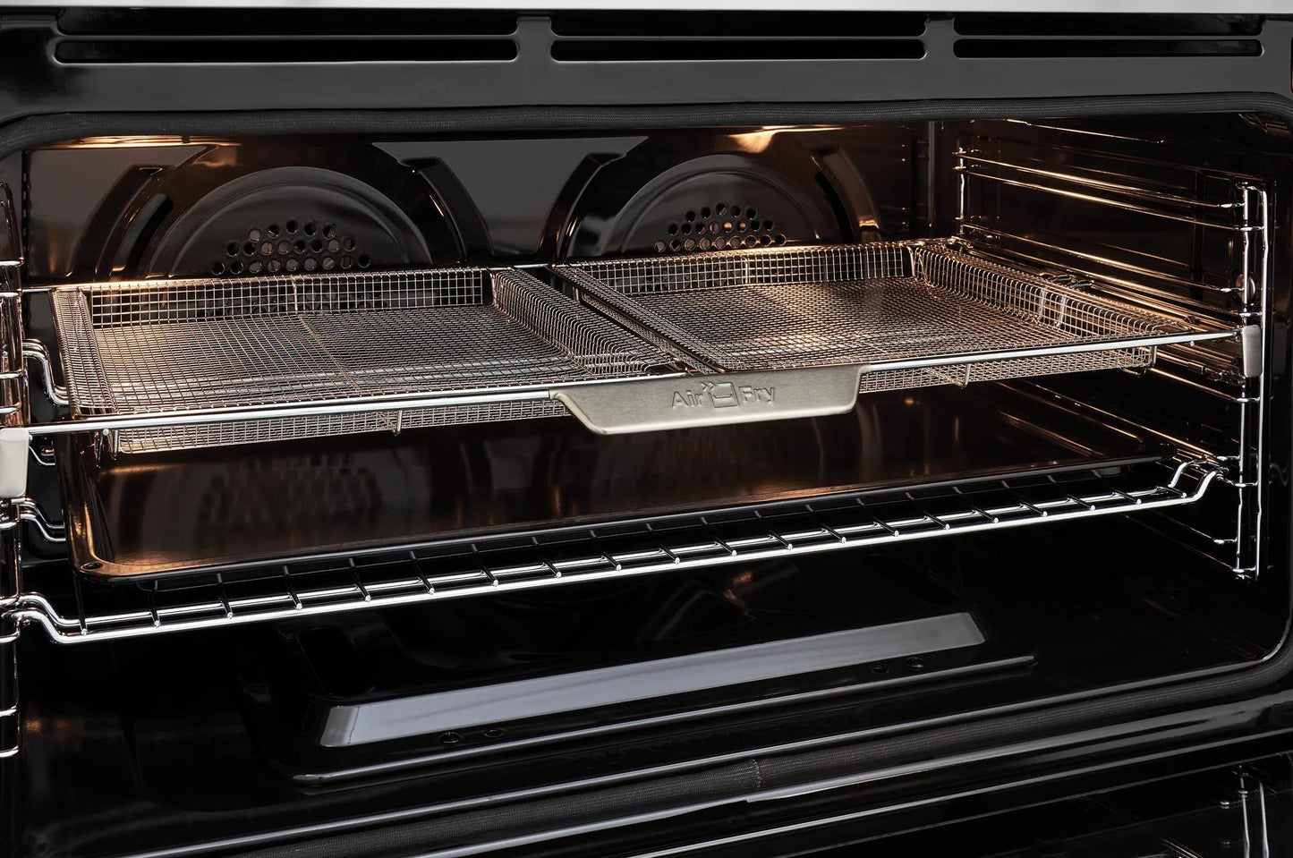 Open oven interior showing dual air fry baskets on metal racks from kitchen appliances collection
