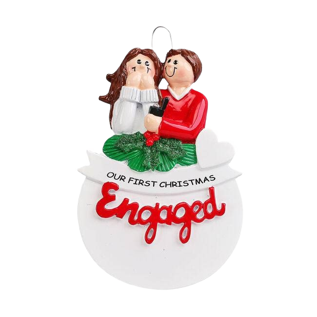 Couple figurine with ring box above wreath and "Our First Christmas Engaged" banner, Christmas ornament under $50